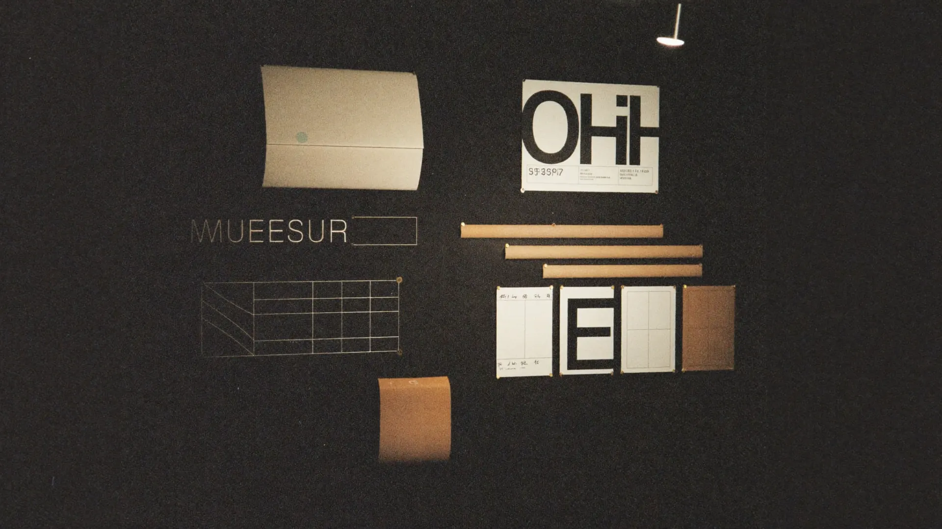Studio wall: type specimens, color chips, layout grids.